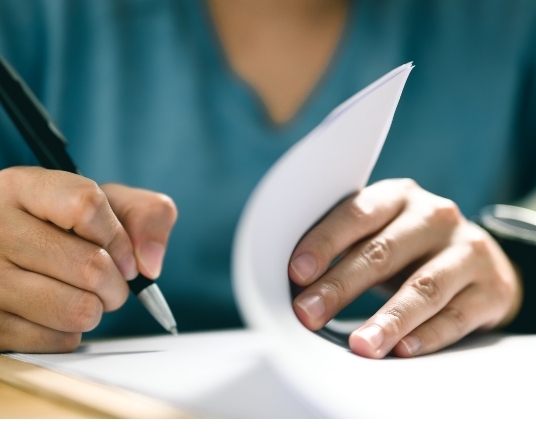 Closeup of a pen signing a document